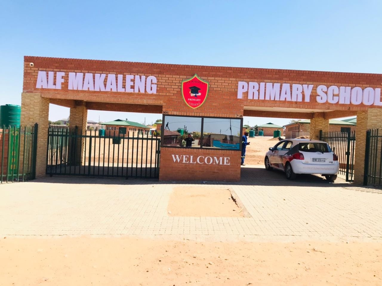 Alf Makaleng Primary School brick entrance arch with 3D lettering, school crest and welcome panel