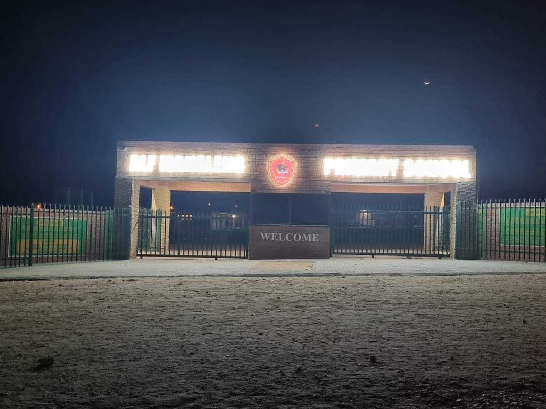 Alf Makaleng Primary School illuminated entrance lettering photographed at night